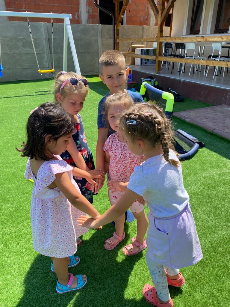 Kids standing in a circle, holding hands